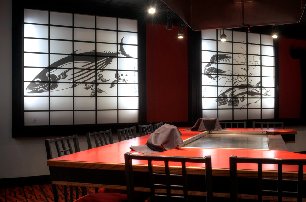 Inside Makoto Japanese Steakhouse with illustrated acrylic panels on wall 3